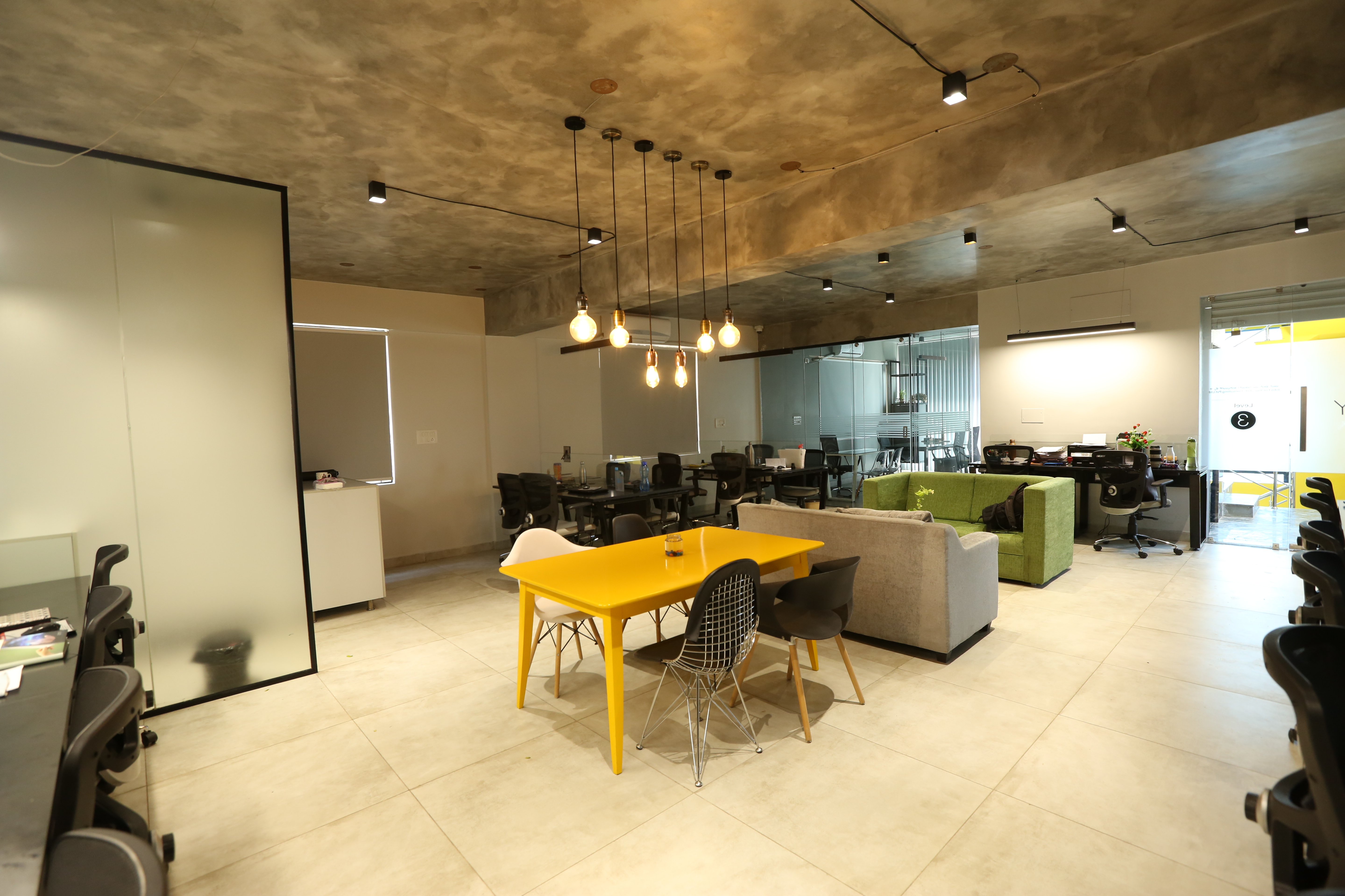 Co-working lounge with Edison pendants by Humming House